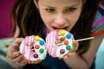girl eating donutz on a stick
