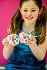 girl eating donutz on a stick